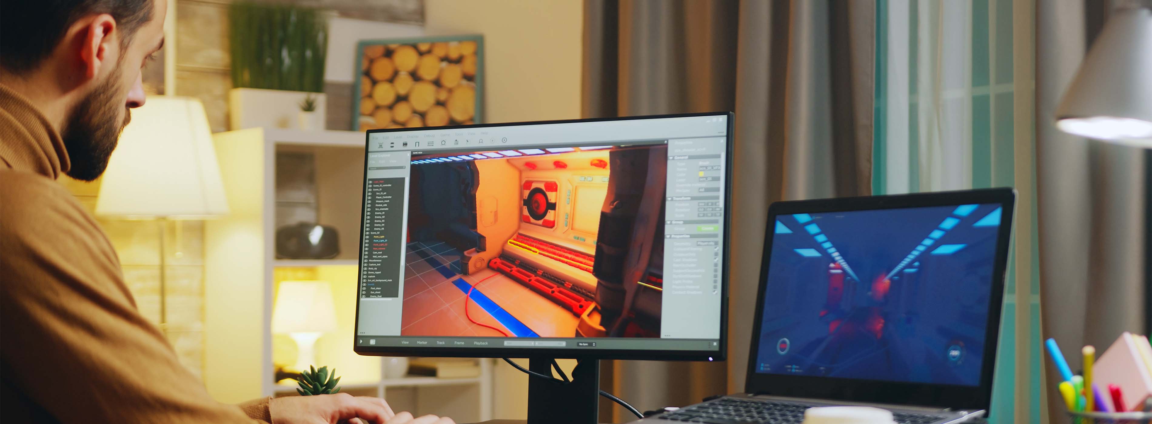 Games 2D - criando seu primeiro jogo - foto de um homem projetando game em software de animação em computador e notebook.