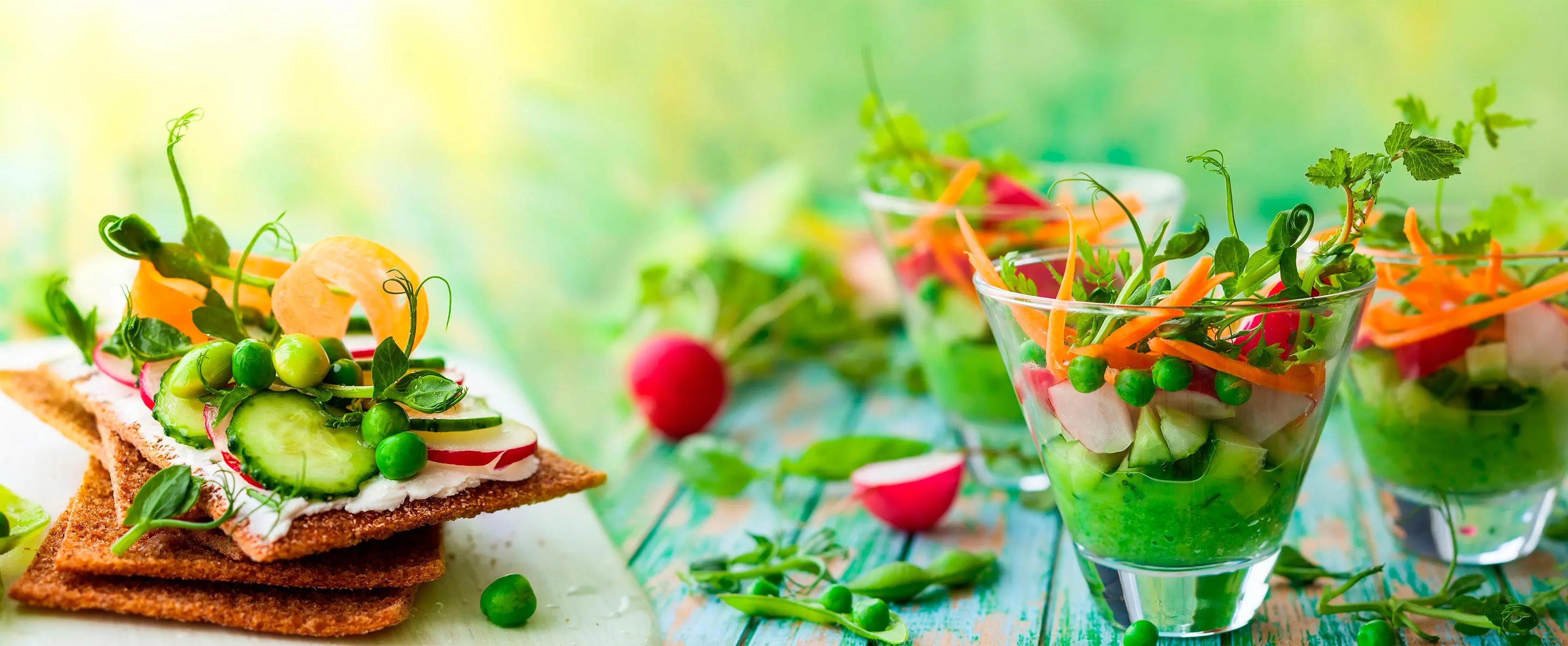 Foto em close de mesa com diversas receitas veganas repletas de verduras.